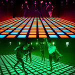Activated MetaNexusXR LED dance grid tiles floor with vibrant lights, ready for interactive touch games. | MetaNexusXR