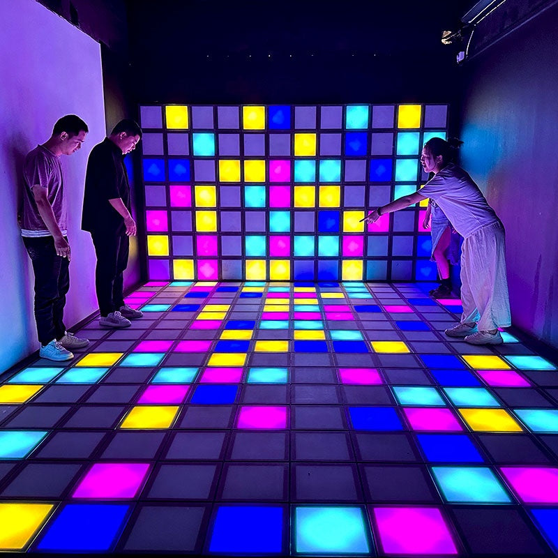 MetaNexusXR interactive LED dance floor with vibrant grid tiles activated for touch games. | MetaNexusXR